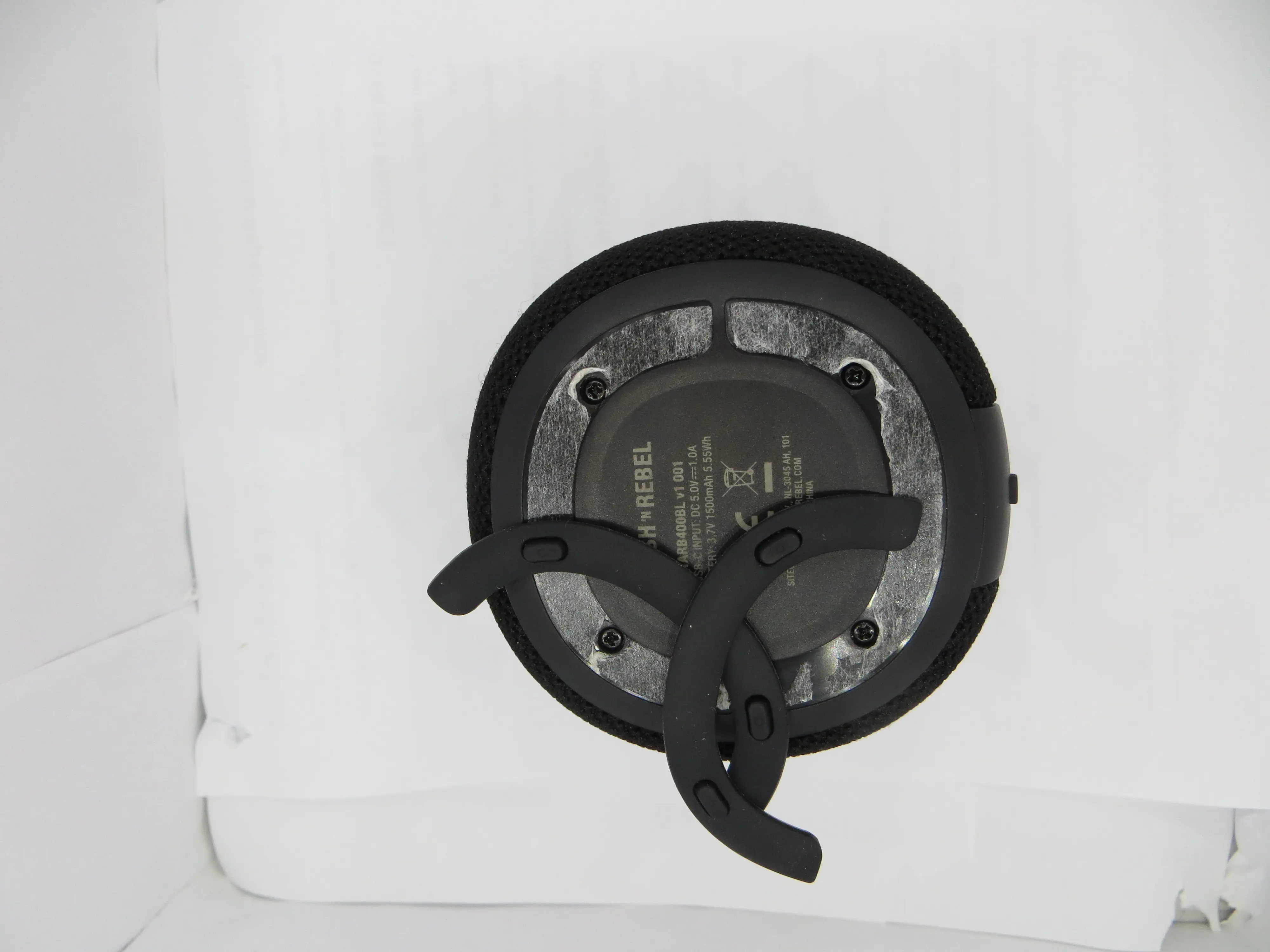 This speaker had no visible screws on the outside. 4 screws where found removing glued on protective caps