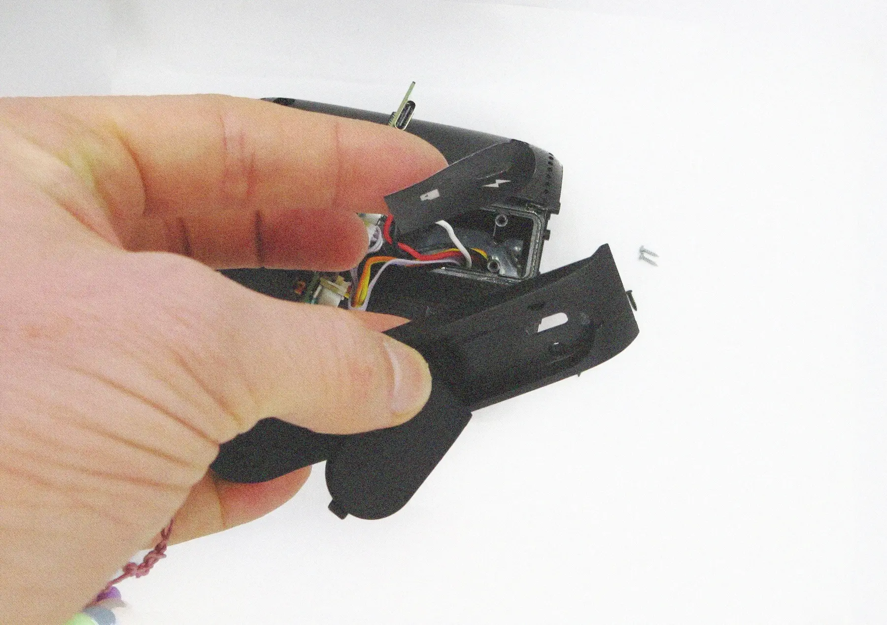The last screw was even better hidden. It was found behind a sticker labeling the two input ports of the device